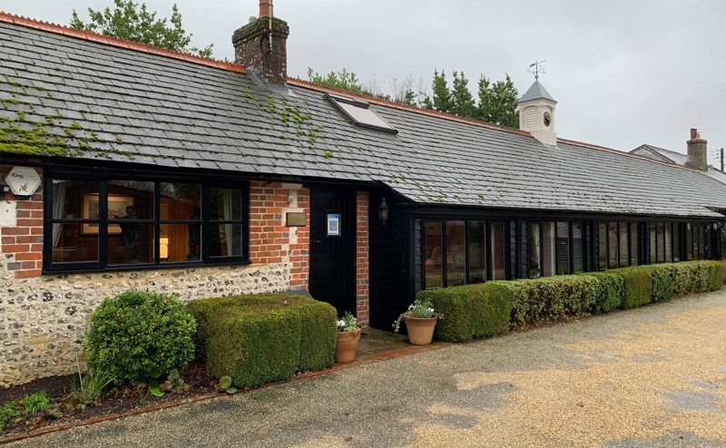 The outside of Ellis Campbell’s office building in Alton, Hampshire. The building is trimmed with black window frames and doors. 
