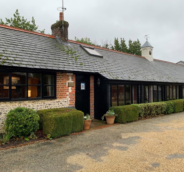The outside of Ellis Campbell’s office building in Alton, Hampshire. The building is trimmed with black window frames and doors. 