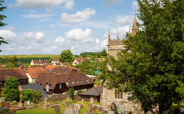 Church and graveyard in the foreground with houses in the background