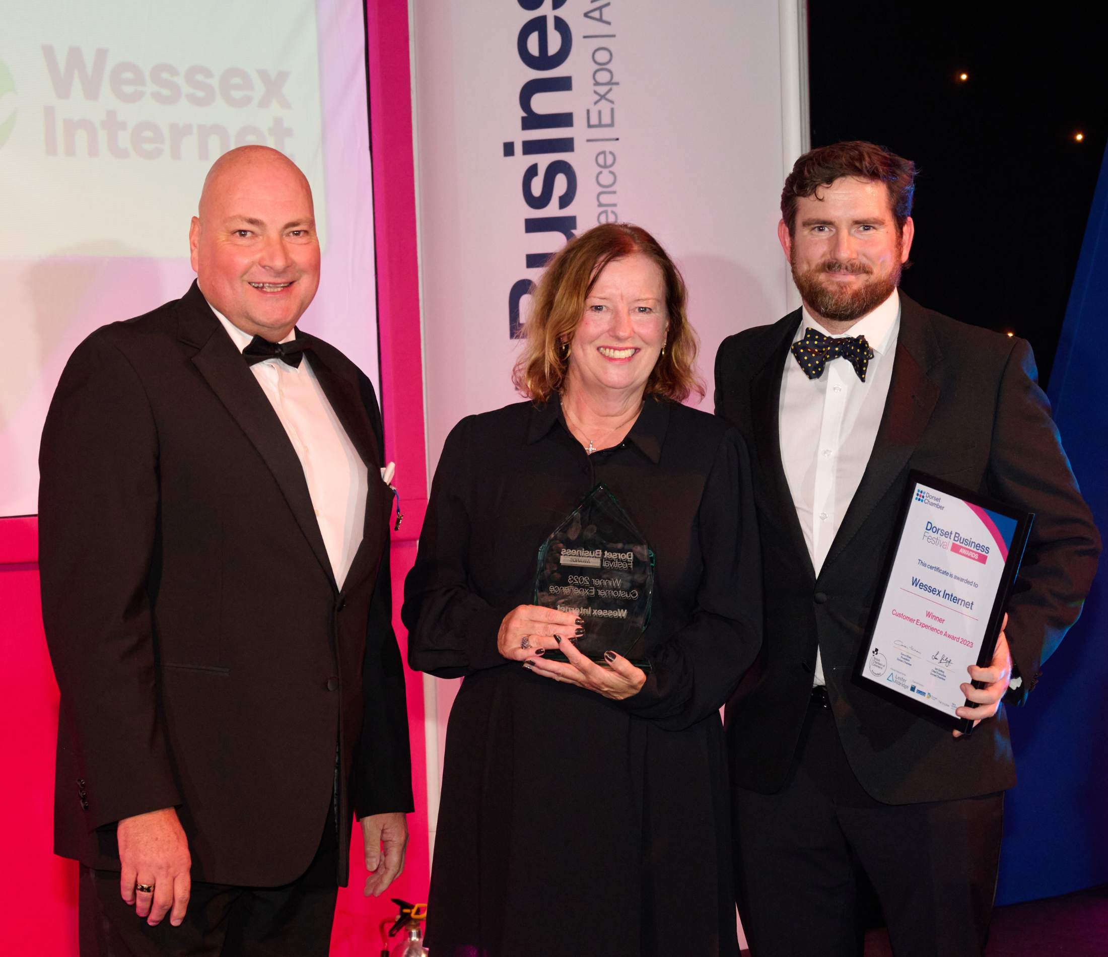 Presenter and Christine and Josh from Wessex Internet at Dorset Business Awards 2023