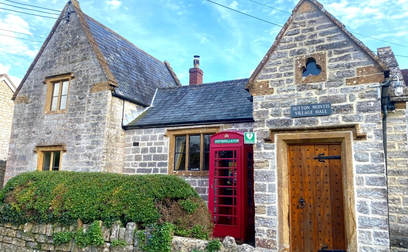 Sutton Montis village hall with red telephone defibrillator box 