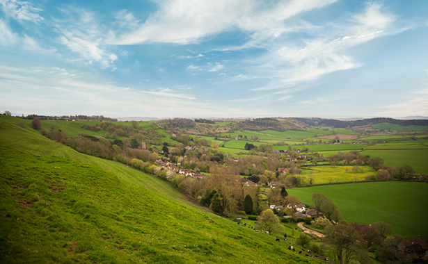 Landscape photo of hills, fields and houses