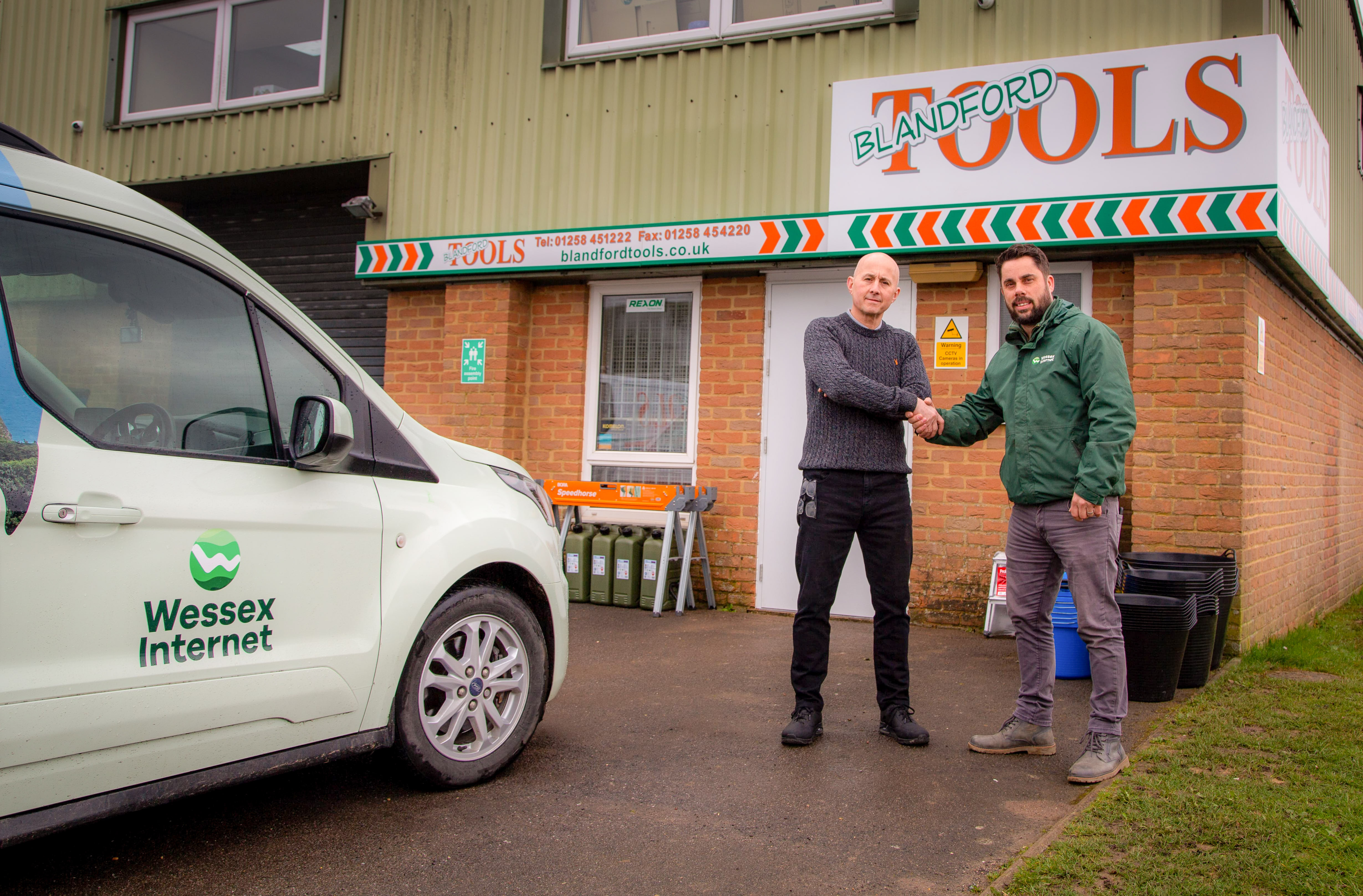 Two people outside Blandford Tools