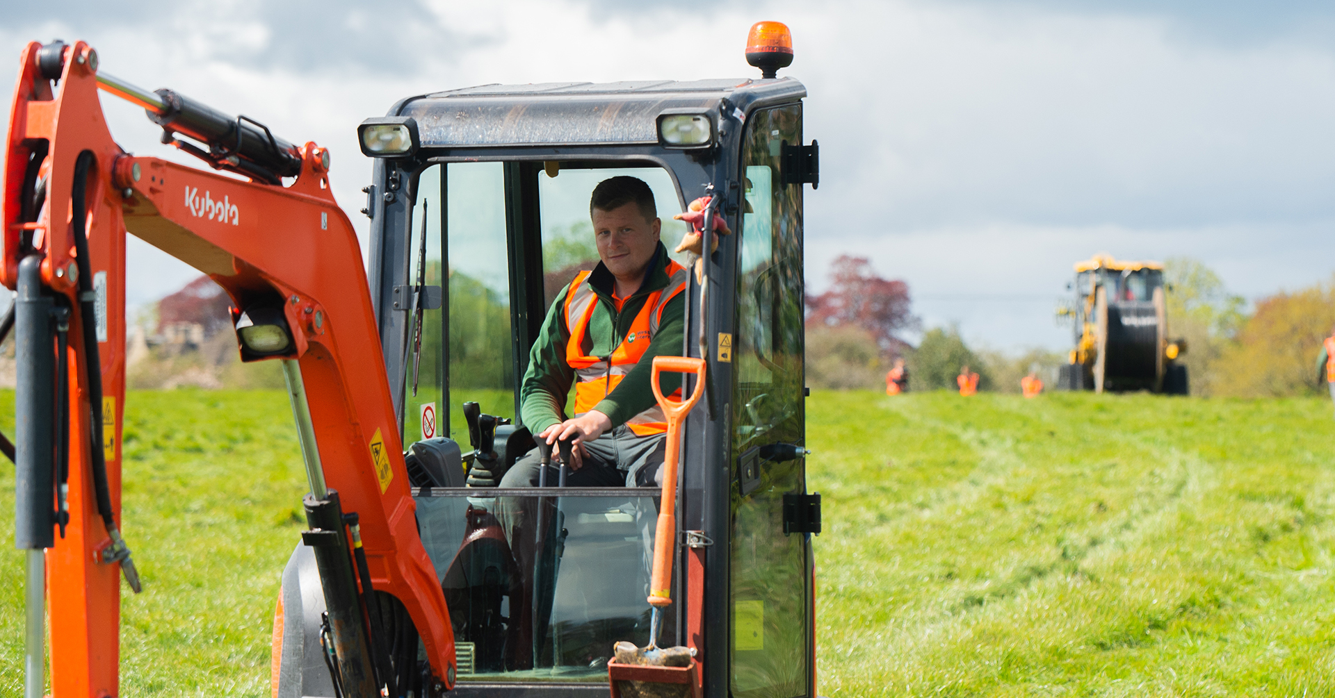 Male employee operating a digger