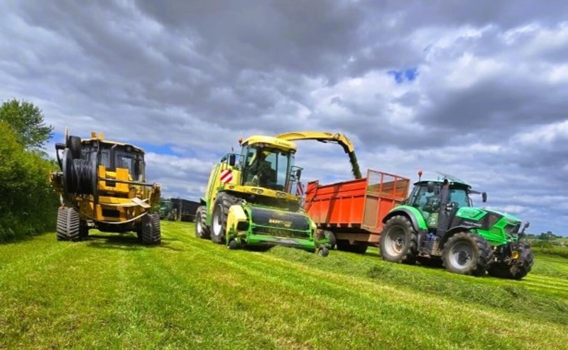 Mole plough and tractor silaging in a field.