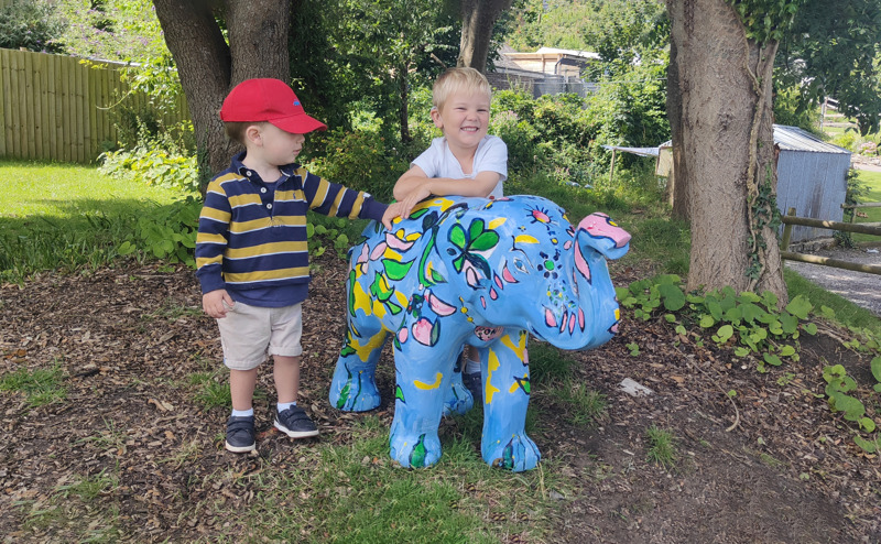Two children and mini elephant sculpture