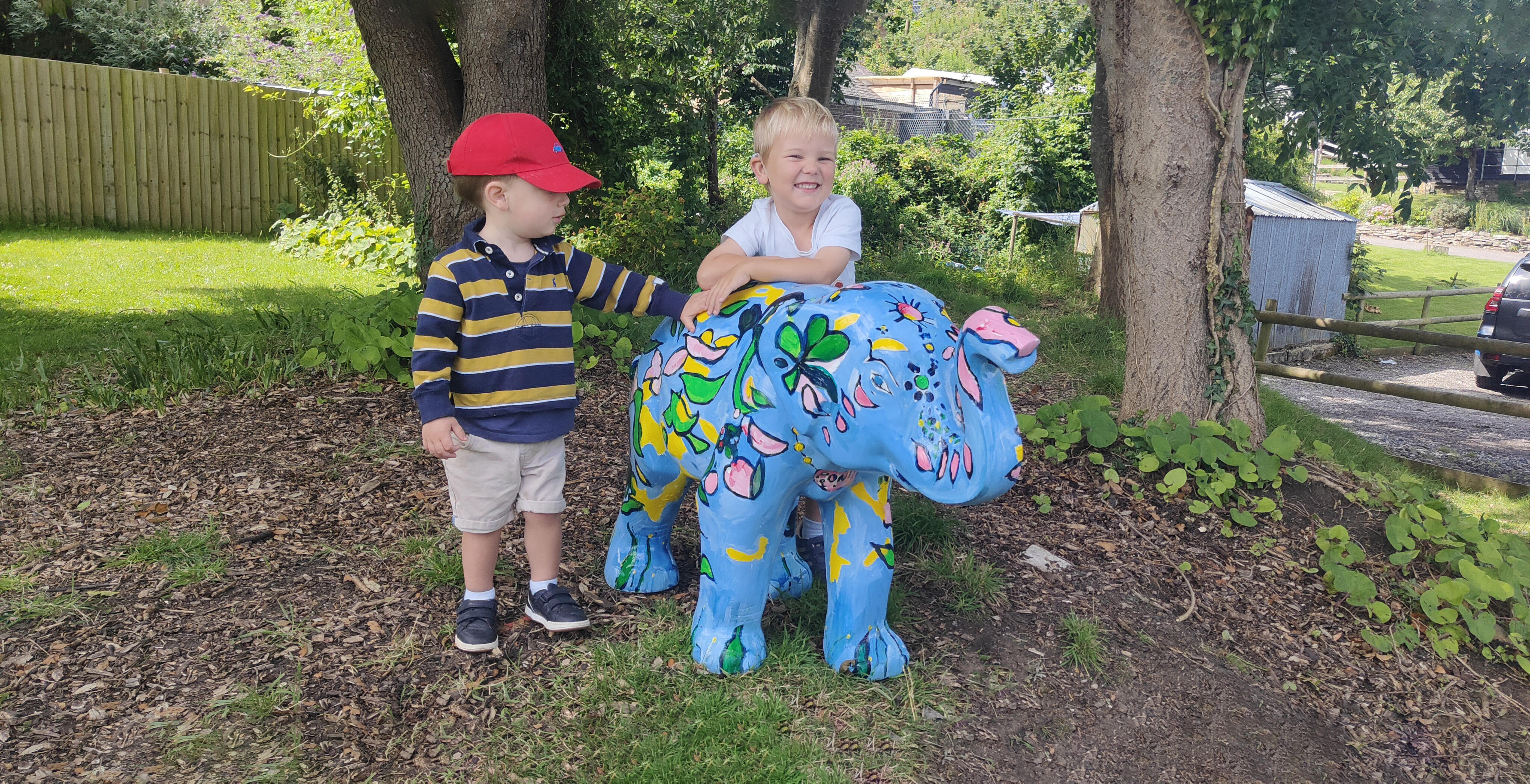 Two children and mini elephant sculpture