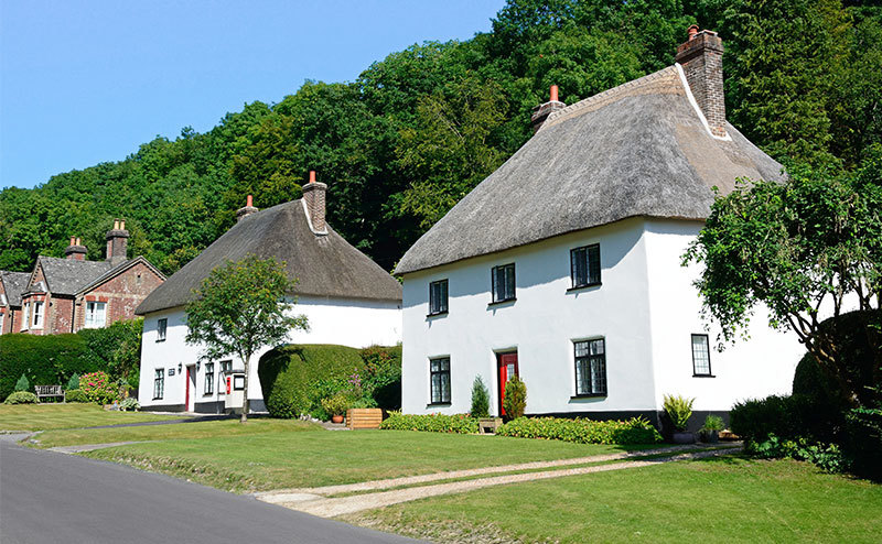 Two detached thatched roof cottages in Milton Abbas.