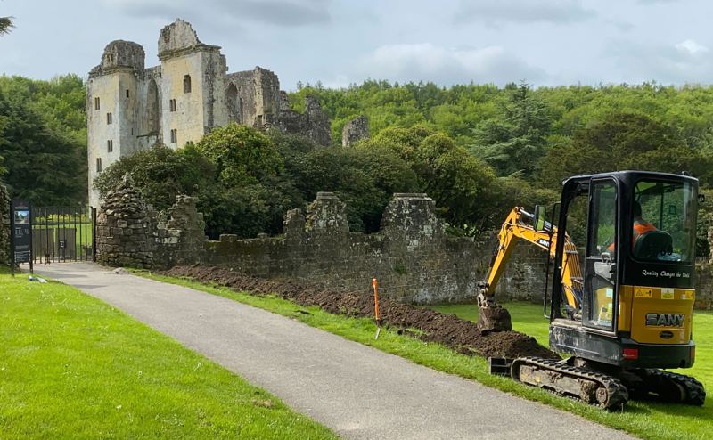 Old Wardour Castle in the background with digger to the right