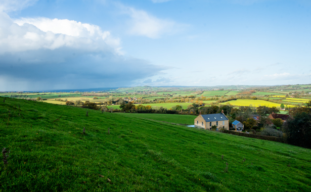 Landscape countryside view with house in the foreground
