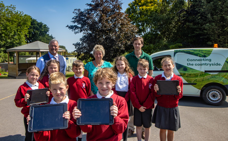 Pupils with iPads alongside Hector Gibson Fleming
