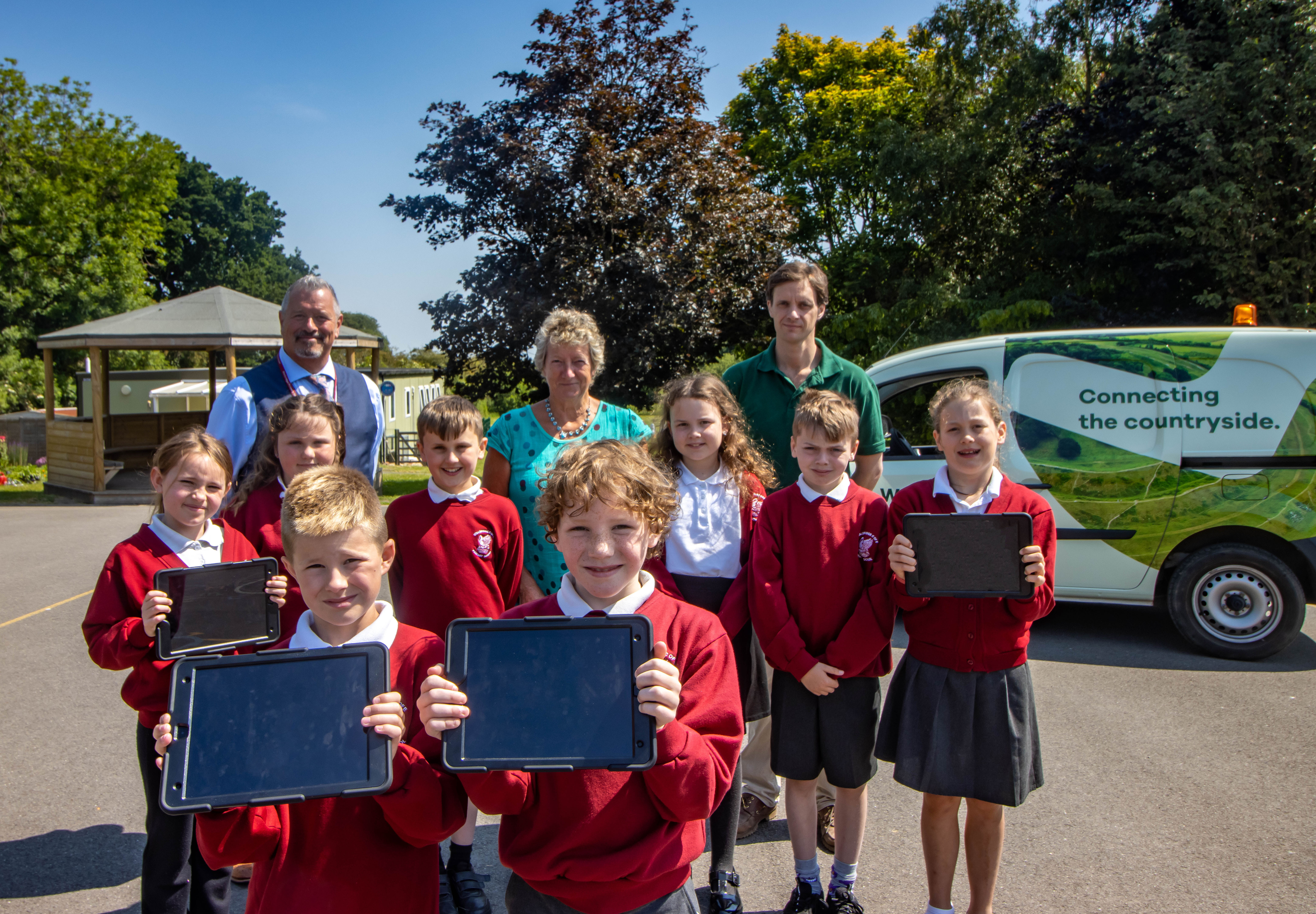 Pupils with iPads alongside Hector Gibson Fleming