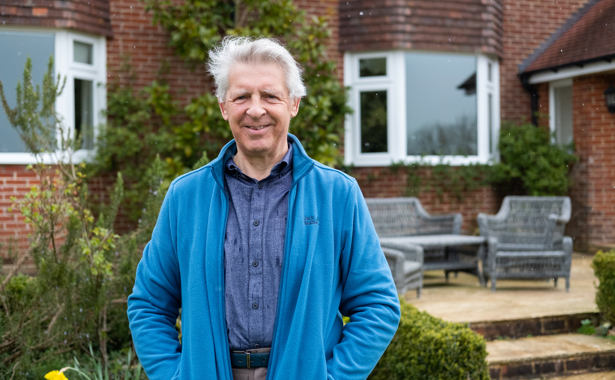 Alastair Fisher in the garden in front of property