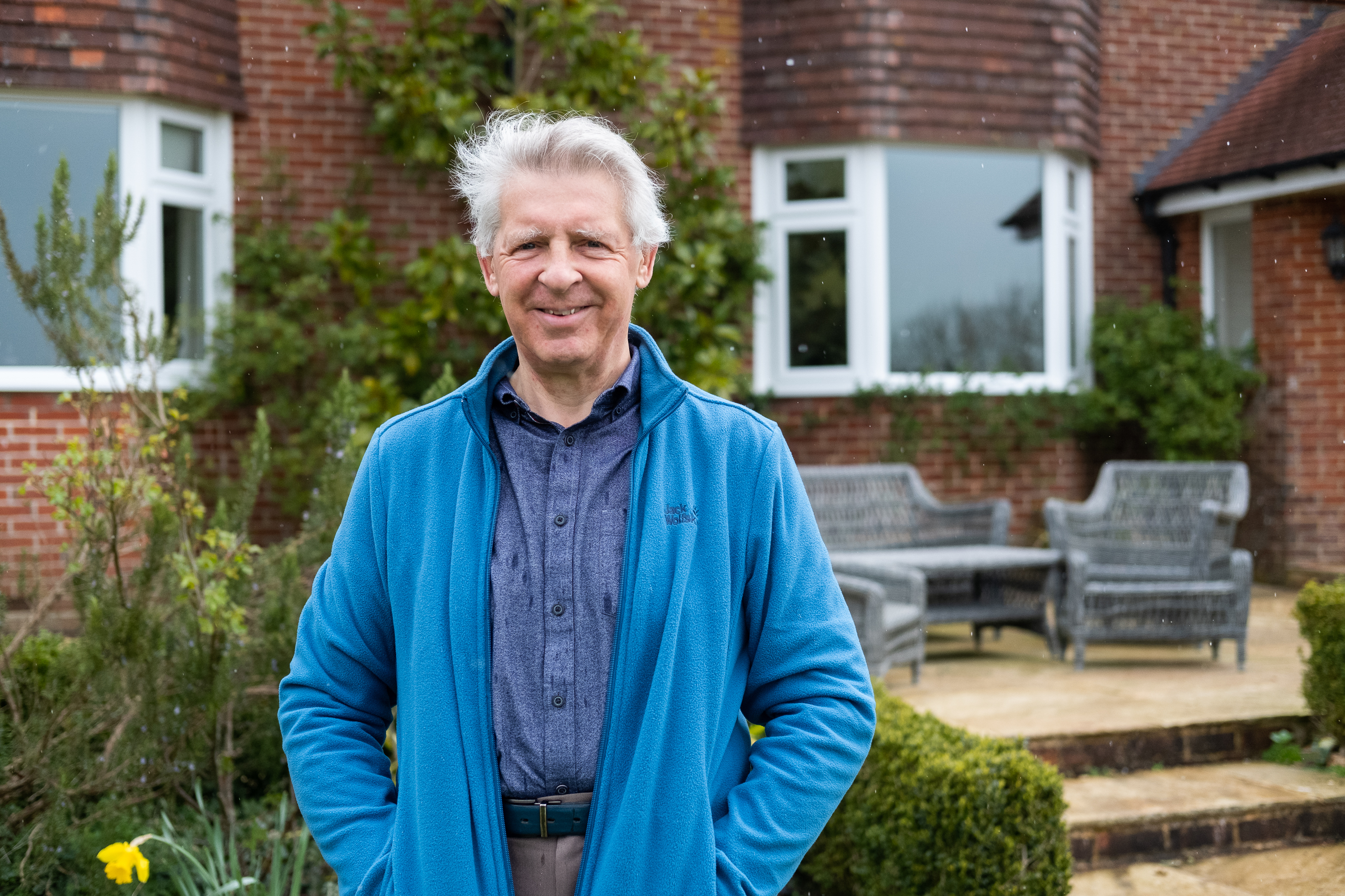Alastair Fisher in the garden in front of property