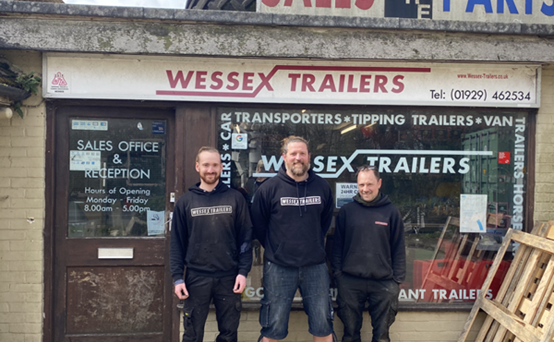 Three men outside Wessex Trailers office