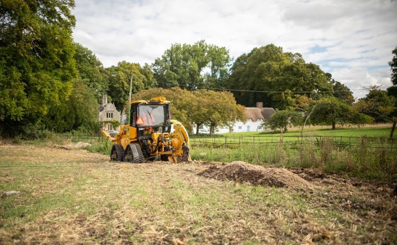 Large mole plough in front of South Wiltshire landscape.