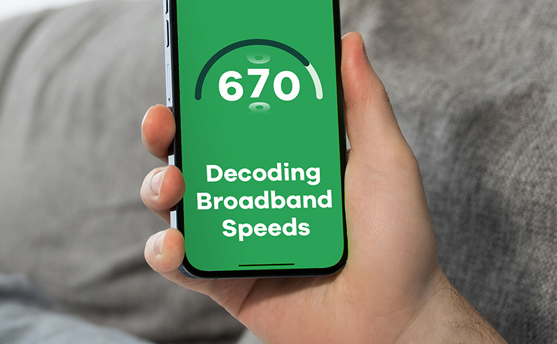 Hand holding a phone saying decoding broadband speeds